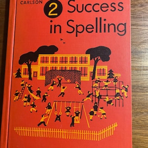 May include: A vintage book titled "Success in Spelling" with a red cover. The cover features a yellow illustration of a school and children playing. The book's title and author's name are in black text.