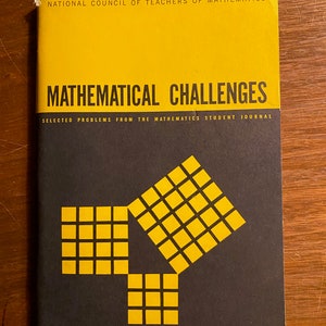 May include: A black and yellow book titled "Mathematical Challenges: Selected Problems from the Mathematics Student Journal" by the National Council of Teachers of Mathematics.