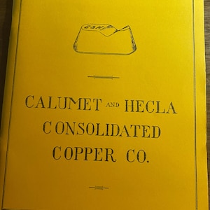 May include: A bright yellow rectangular document cover featuring a black line drawing of a copper ingot marked C&H at the top. The text reads CALUMET AND HECLA CONSOLIDATED COPPER CO. in black capital letters, centered within a thin black border.