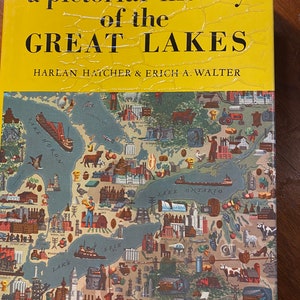 May include: A hardcover book titled "a pictorial history of the GREAT LAKES" with a yellow cover and a detailed map illustration. The map depicts the Great Lakes region with various landmarks and illustrations. The authors' names are Harlan Hatcher & Erich A. Walter.