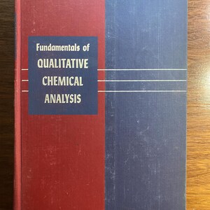 May include: A hardcover book titled "Fundamentals of Qualitative Chemical Analysis." The book has a red spine and a blue and red cover. The title is in white text on a blue background.