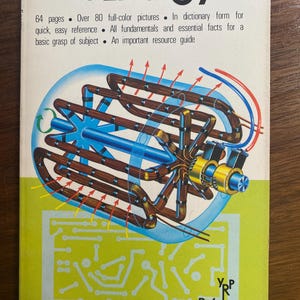 May include: A vintage book titled "The World of Energy" with a colorful illustration of a mechanical device. The cover features text about the book's contents, including full-color pictures and essential facts. The book is from Reference Library Books.