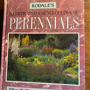 May include: A book titled "Rodale's Illustrated Encyclopedia of Perennials" by Ellen Phillips & C. Colston Burrell. The cover features a colorful photograph of a lush perennial garden.