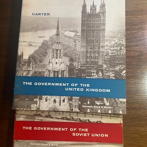 May include: Two vintage hardcover books with blue and red covers. The top book has a black and white photo of the Houses of Parliament in London, England. The text on the cover reads "The Government of the United Kingdom" and "Harcourt, Brace & World". The bottom book has the text "The Government of the Soviet Union" and "Harcourt, Brace & World".