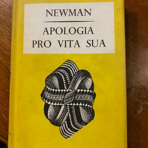 May include: A yellow book with the title "Newman Apologia Pro Vita Sua" and the text "Everyman's Library 636" on the cover.