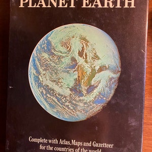 May include: The Illustrated Encyclopedia of the Planet Earth book cover features a blue and green globe with clouds. The text on the cover reads "The Illustrated Encyclopedia of the Planet Earth" and "Complete with Atlas, Maps and Gazetteer for the countries of the world."