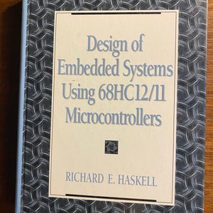 May include: A book titled "Design of Embedded Systems Using 68HC12/11 Microcontrollers" by Richard E. Haskell. The cover features a blue and gray patterned design.