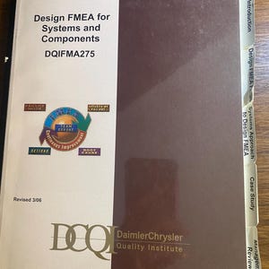 May include: A book titled "Design FMEA for Systems and Components" with the code DQIFMA275. The cover features a logo with the words "FMEA" and "Team Effort". The book is published by the DaimlerChrysler Quality Institute.