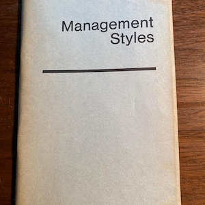 Può includere: Un libro beige con il titolo "Management Styles" stampato in nero.
