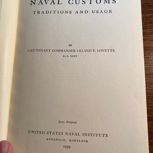 May include: A book titled "Naval Customs Traditions and Usage" by Lieutenant Commander Leland P. Lovette, U.S. Navy. Published by the United States Naval Institute in Annapolis, Maryland in 1939.