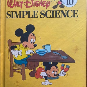 May include: A vintage Walt Disney "Simple Science" book with Mickey Mouse illustrations. The cover is yellow with the title in red and black. Mickey Mouse is depicted in various poses, interacting with a table and a magnet. The book is part of the "Fun-to-Learn Library" series.