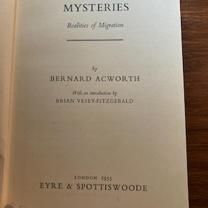 May include: An open book with the title "BIRD AND BUTTERFLY MYSTERIES" by Bernard Acworth. The book's pages are a light beige colour, with black text. The text includes the title, author's name, and publisher's information. Published in London in 1955.