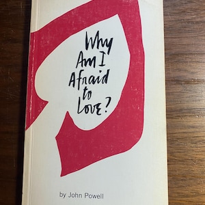 May include: A book titled "Why Am I Afraid to Love?" by John Powell. The cover features a red heart shape with the title in black text.