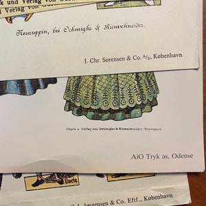 May include: A vintage paper doll with a green and white dress. The doll is from a book published by Gustav K&uuml;hn in Neuruppin, Germany. The text on the page reads "Druck u Verlag von Oehmigke & Riemschneider, Neuruppin".