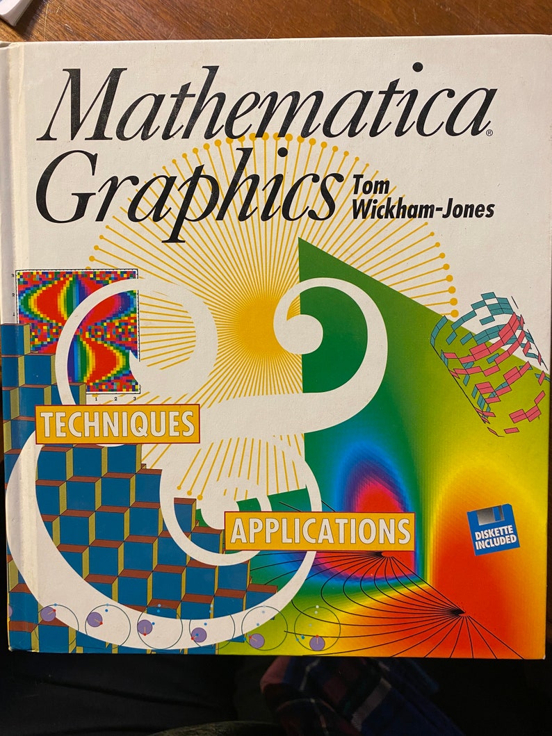 May include: A book titled "Mathematica Graphics" by Tom Wickham-Jones. The cover features colorful geometric patterns and illustrations, with the words "Techniques" and "Applications" highlighted. A small blue icon indicates a diskette is included.