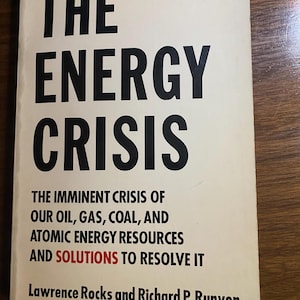 May include: A book titled "THE ENERGY CRISIS" with the subtitle "THE IMMINENT CRISIS OF OUR OIL, GAS, COAL, AND ATOMIC ENERGY RESOURCES AND SOLUTIONS TO RESOLVE IT." The cover is off-white with black text and the price £2.36.