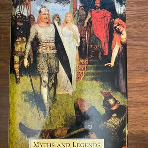Puede incluir: Un libro titulado "GERMANY" con las palabras "MYTHS AND LEGENDS" en la portada. La portada muestra una escena histórica con figuras con armaduras y túnicas fluidas, sobre un fondo verde y marrón.