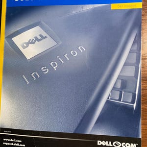 May include: A Dell Inspiron 8000 system solutions guide with a blue cover and the Dell logo. The cover features a close-up of a Dell Inspiron laptop with a silver finish and a black keyboard.