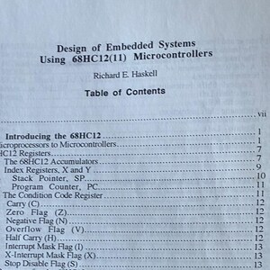 May include: A black and white book titled "Design of Embedded Systems Using 68HC12(11) Microcontrollers" by Richard E. Haskell. The table of contents lists the chapters and page numbers for the book.