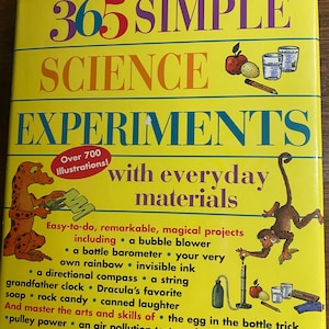 May include: A yellow book cover for "365 Simple Science Experiments", featuring colourful text and illustrations. It details experiments using everyday materials, including bubble blowers and invisible ink, with over 700 illustrations. The book is designed for easy science projects.