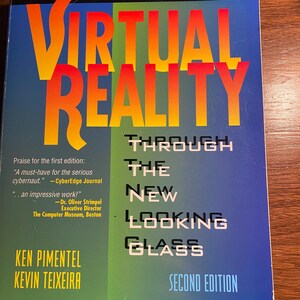 May include: A blue, green, and yellow book titled "Virtual Reality Through The New Looking Glass" with the subtitle "Second Edition". The book cover features the Intel logo and the Windcrest McGraw-Hill logo. The book is about virtual reality.
