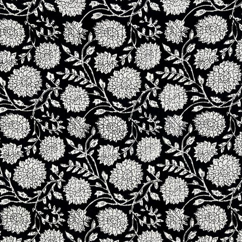 May include: A black fabric featuring a repeating white floral pattern. The design consists of stylized, textured flowers with multiple petals and thin, winding stems with small leaves, creating a dense, continuous botanical print across the surface.