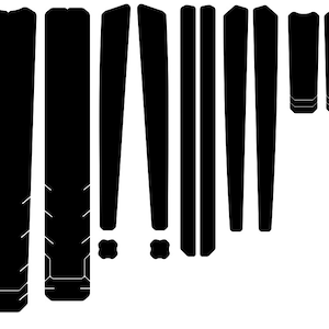 May include: A set of black vinyl stickers for a skateboard deck. The stickers are shaped like various geometric shapes, including rectangles, triangles, and squares.