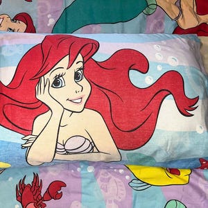 May include: A set of three ceramic mugs with a speckled, matte finish. Each mug features a different color: light blue, cream, and gray. The mugs have a simple, modern design and a comfortable handle.