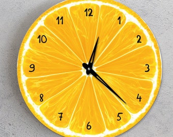 May include: A yellow lemon-shaped clock with black hands and black numbers around the edge. The clock face is a close-up of a lemon slice.
