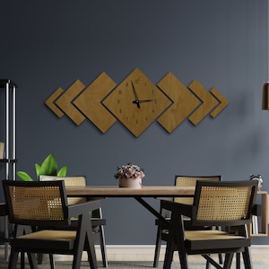 May include: A dining room with a wooden table and four black chairs with woven cane seats. The wall is painted a dark blue and features a geometric wooden clock with Roman numerals.