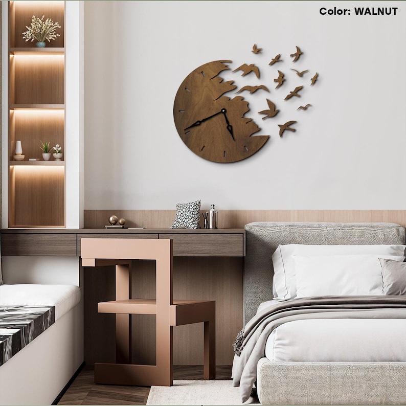 May include: A walnut-colored wooden wall clock with a unique design. The clock face is a circle with a portion cut out, and a flock of birds appears to be flying away from it. The clock hands are black.