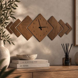 May include: A wall clock featuring a central diamond-shaped wooden panel with black numerals from 1 to 12 and black hands. The clock is flanked by four additional diamond-shaped wooden panels of varying sizes, creating a horizontal geometric design.