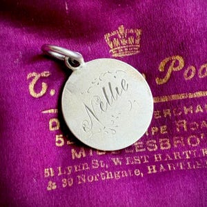 Colgante de moneda victoriana con símbolo de amor «Nellie» (hacia 1890)
