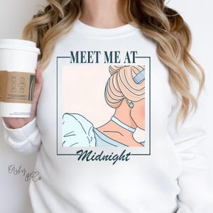 May include: White sweatshirt with a graphic of a cartoon princess with the text "Meet Me At Midnight".