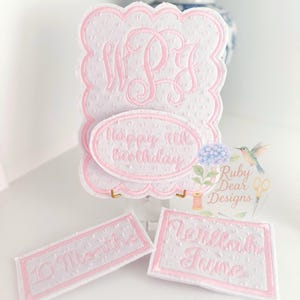 May include: A set of embroidered patches in white and pink. The main piece has a scalloped edge and features the initials "W P J" and the text "Happy 4th Birthday". Two smaller patches read "10 Months" and "Verillah June".