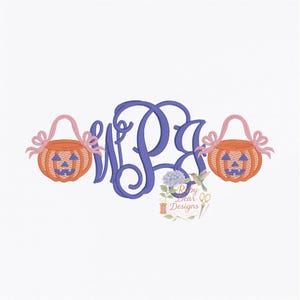 May include: A monogram design featuring a large, stylized blue letter set with two orange jack-o'-lantern baskets on either side. The baskets have pink handles and bows. The design includes floral and hummingbird accents.