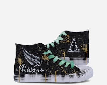 May include: Black high-top sneakers with mint green laces. The shoes feature gold paint splatter and the word "Always" with a feather design. The Deathly Hallows symbol is also visible on the side.