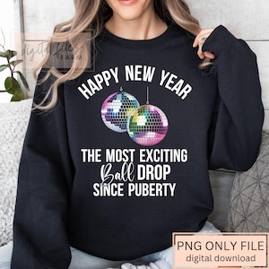 May include: Black sweatshirt with the text "HAPPY NEW YEAR" and "THE MOST EXCITING Ball DROP SINCE PUBERTY". The design includes two disco balls. The bottom right corner has the text "PNG ONLY FILE digital download".