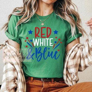 May include: Green t-shirt with the text "RED WHITE & BLUE" in red, white, and blue lettering with stars and fireworks around the text.