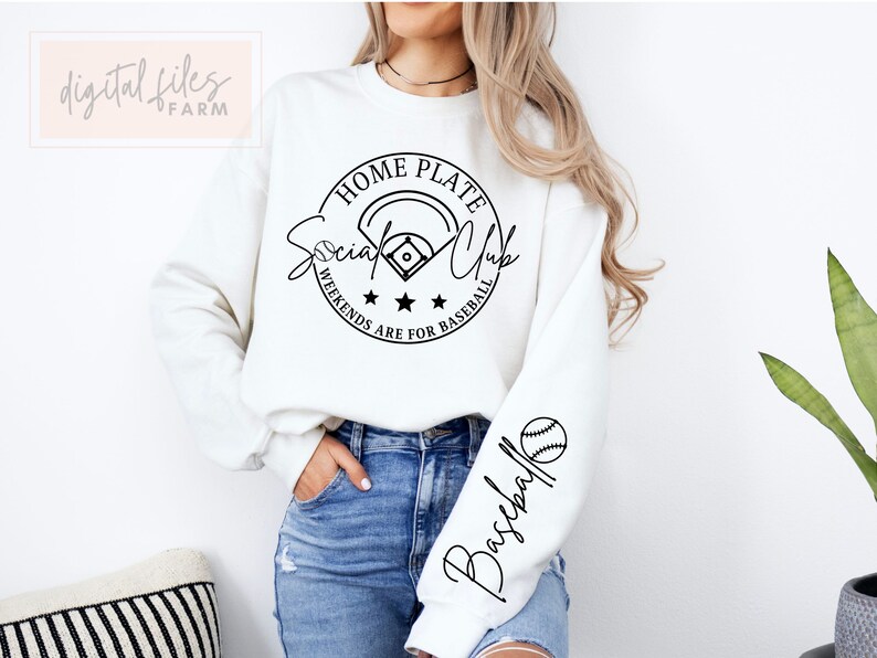 May include: White sweatshirt with a black circle graphic that says "Home Plate Social Club" with a baseball and stars. The sleeve has a black graphic that says "Baseball".