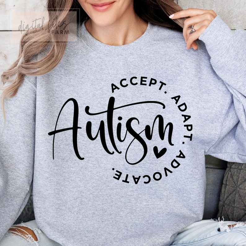 May include: Gray sweatshirt with a black circle graphic that says "Accept. Adapt. Advocate. Autism" with a small heart.