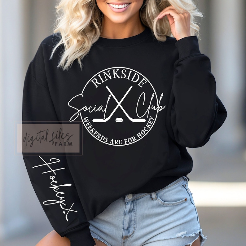 May include: Black sweatshirt with a white circle graphic that says "Rinkside Social Club Weekends Are For Hockey" with a hockey stick and puck design. The left sleeve has the word "Hockey" written vertically in white.