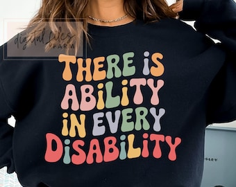 May include: Black sweatshirt with the text "THERE IS ABILITY IN EVERY DISABILITY" in colorful, retro-style lettering. The design features orange, green, yellow, purple, and red text on a dark background.