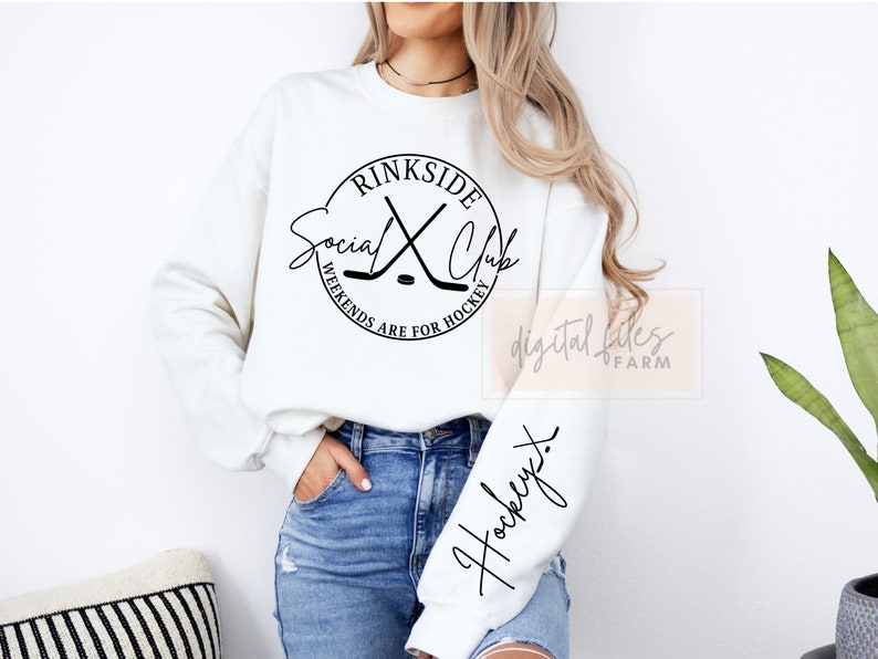 May include: White sweatshirt with a black circle graphic that says "rinkside social club" with hockey sticks and a puck. The text around the circle says "weekends are for hockey". The sleeve of the sweatshirt has the word "hockey" written in cursive.