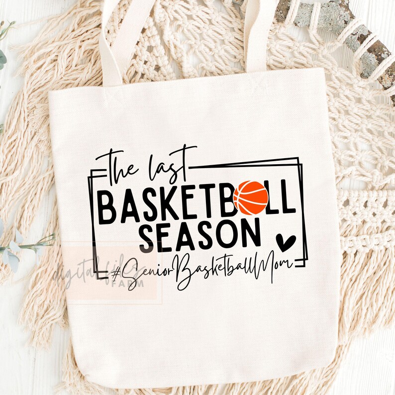 May include: White canvas tote bag with black text that reads "The last basketball season" with a basketball graphic and a heart. The text "#Senior Basketball Mom" is written in cursive below the main text.