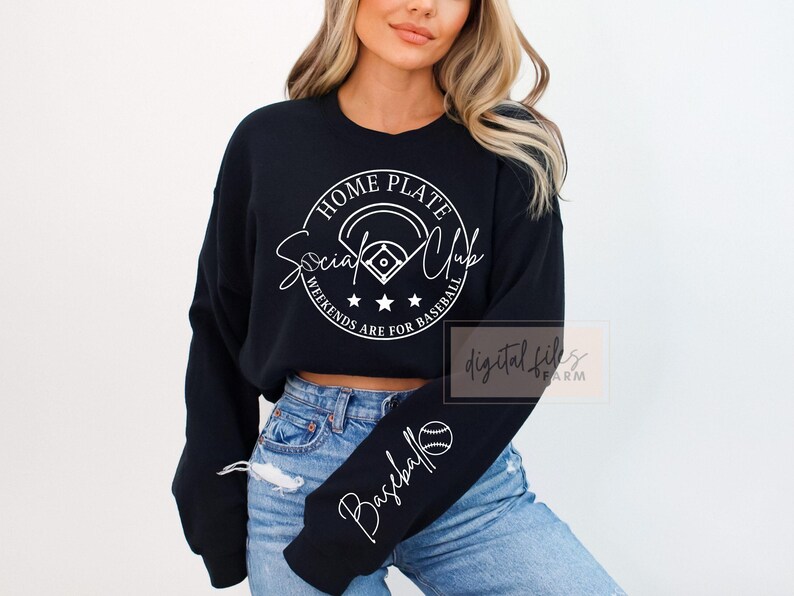 May include: Black cropped sweatshirt with white text that reads "Home Plate Social Club Weekends Are For Baseball". The sweatshirt has a baseball graphic and a baseball on the sleeve.