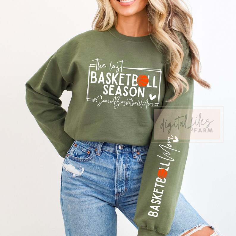May include: Green long-sleeve sweatshirt with the text "The last basketball season #SeniorBasketballMom" and a basketball graphic on the front. The sweatshirt has a basketball graphic on the sleeve.