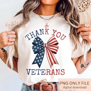 May include: Cream-colored t-shirt featuring a patriotic bow design with blue stars and red stripes. The words "THANK YOU VETERANS" are printed above and below the bow in navy blue. The shirt is a PNG file, available as a digital download.