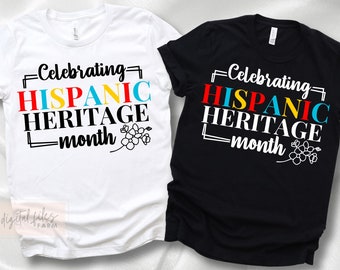 Puede incluir: Dos camisetas, una blanca y otra negra, con el texto "Celebrating Hispanic Heritage Month" en letras de colores y un diseño floral.