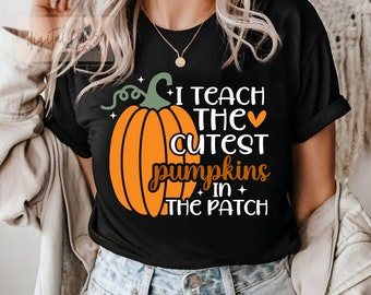 May include: Black t-shirt with a pumpkin graphic and the text "I teach the cutest pumpkins in the patch".